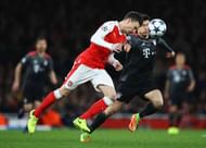 LONDON, ENGLAND - MARCH 07:  Laurent Koscielny of Arsenal beats Robert Lewandowski of Bayern Muenchen to the ball during the UEFA Champions League Round of 16 second leg match between Arsenal FC and FC Bayern Muenchen at Emirates Stadium on March 7, 2017 in London, United Kingdom.  (Photo by Clive Mason/Getty Images)
